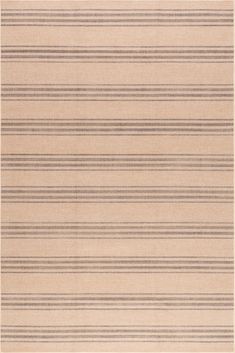 a beige rug with black stripes on it