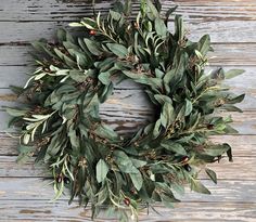 "Faux Eucalyptus and Olive mixed Greenery Farmhouse wreath Finished size - approx 25\" from tip to tip  This gorgeous farmhouse greenery wreath is just what you were looking for!  It makes a striking statement hanging on ship lap, a gothic style mirror or antique window frame to accessorize any room in your home with the extremely popular farmhouse look.  Naturally, it's also ideal on your front door! Or perhaps it could be used at your country wedding! This full and lush wreath is designed using long leaf faux eucalyptus with small buds and faux olive branches, complete with small faux olives. The greens coordinate together beautifully and make this wreath perfect in every way!   This wreath is hand made in Charleston, South Carolina. The finished wreath measures approximately 25\" from t Faux Olive Branches, Purple Christmas Wreath, Front Door Indoor, Antique Window Frames, Gold Laurel Wreath, Wreath Stand, White Pine Tree, Antique Window, Gorgeous Farmhouse