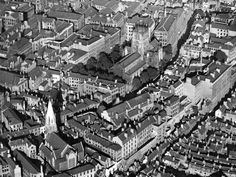 an old black and white photo of a city with lots of tall buildings on it