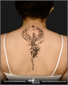 the back of a woman's neck with tattoos on it