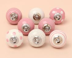 pink and white ceramic knobs with polka dots on them