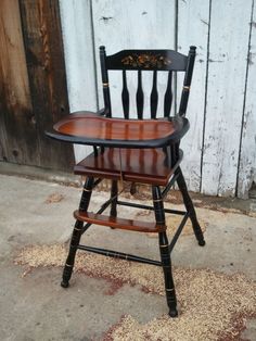 a wooden chair sitting on top of a sidewalk