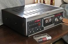 an old radio sitting on top of a wooden table