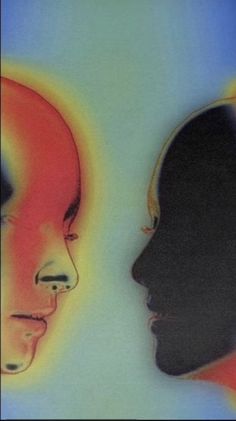 two people are facing each other with different colored faces