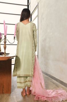 Adorned on pure raw silk, in a pastel pistachio green with zari and sequins details. The length of the long kameez is 46 inches. Accompanied with a pure raw silk zari shalwar and pure organza dupatta in a contrasting teapink tone featuring zari embellishments with gotah florals. An alluring three piece with old world c Long Kameez, Baby Frocks Designs, Pistachio Green, Organza Dupatta, Frock Design, Pakistani Outfits, Raw Silk, Beauty Inspiration, Pistachio