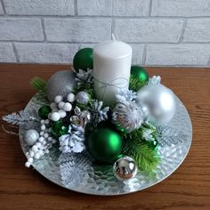 a glass plate with ornaments and a candle on it