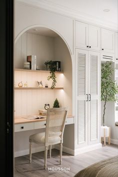 a white desk and chair in a room with built - in closets on the wall