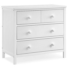 a white dresser with four drawers and three knobs