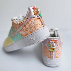 Neha Assar has literally given Nike AF1 sneakers a South Asian bridal makeover! These one-of-a-kind sneakers are hand painted with pale yellow, pastel mint and soft peach with matte white mehndi inspired art. The pattern play on these sneakers is what gives them personality. Moghul motifs are placed adjacent to florals on one side and intricate mehndi patterns on the other. The patterns should not be mistaken for being stenciled as each motif/line/curve/dot is done by hand. The shoes are hand em Pastel High-top Custom Sneakers For Streetwear, Pastel Lace-up Custom Sneakers For Streetwear, Pastel Sneakers For Spring Streetwear, Pastel High-top Sneakers For Spring, Hand Painted Pink Sneakers For Spring, Pastel Lace-up Spring Sneakers, Hand Painted Low-top Sneakers For Spring, Nike Shoes Art, Bejeweled Sneakers