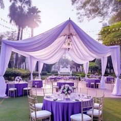 an outdoor wedding venue with purple and white decor