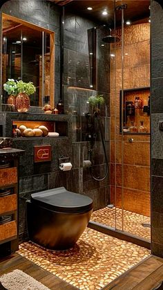 a bathroom with a large black bathtub next to a walk in shower