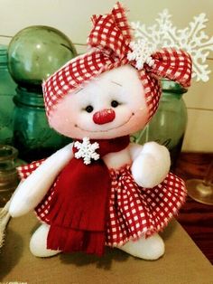 a white teddy bear wearing a red and white dress