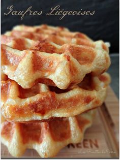 three waffles stacked on top of each other in front of a wooden board