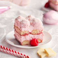 two pieces of cake on a plate with raspberries