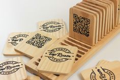 several wooden coasters with qr code stamps on them