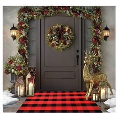 a christmas door decoration with candles and deer figurines on the front porch, surrounded by holiday decorations