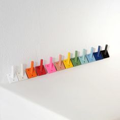 a row of multicolored plastic pegs sitting on top of a white counter