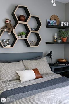 a bed room with a neatly made bed and two shelves on the wall above it