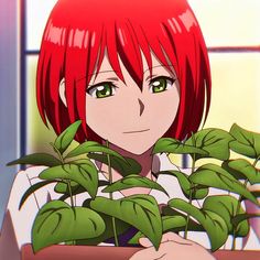 a girl with red hair and green eyes holding a potted plant