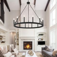 a living room filled with furniture and a fire place in the middle of the room