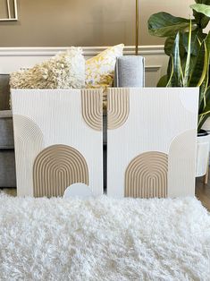 a living room filled with furniture next to a white rug and large potted plant