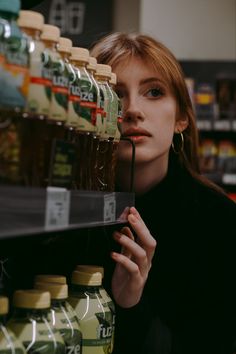 a woman is looking at the shelves in a grocery store