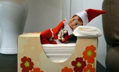 an elf is sitting on top of a toilet