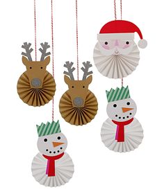 three paper christmas decorations hanging from strings