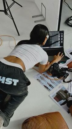 a woman sitting at a table with a laptop computer on it's lap top