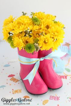 a pair of pink boots with yellow flowers in them