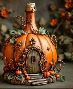 a pumpkin shaped bottle with a house inside