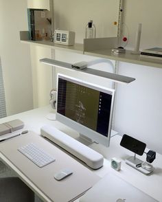 a computer monitor sitting on top of a white desk