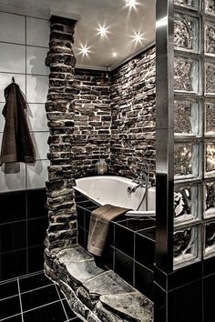 a black and white photo of a stone shower