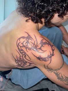 a man with a tattoo on his back