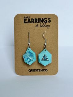 the earrings are made from blue paper and have an origami design on them