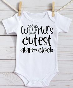 a white onesuit with the words world's cutest alarm clock on it