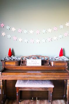 a grand piano is decorated with stars and garland