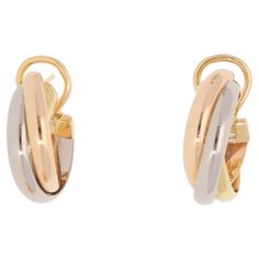 A classic pair of vintage Cartier trinity hoop earrings set in 18k yellow, rose and white gold. Each hoop is set in the iconic trinity design and is composed of three 3-millimetre bands, which are soldered together to create the hoop. They are secured to reverse with a post and omega clip fitting. Due to their size and design these would make a perfect pair of everyday hoop earrings. For the size reference, the hoops each measure approximately 2.0 centimetres in length and 0.7 centimetres in wid Hoop Earring Sets, Yellow Rose, Trinidad, Vintage Cartier, Earrings Set, Cartier, Perfect Pair, Earring Set, 18k Gold