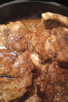 meatballs and gravy cooking in a skillet