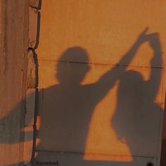 a shadow of a person holding a skateboard