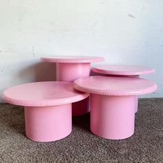 three pink stools stacked on top of each other