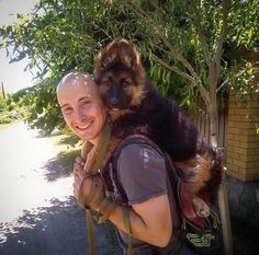 a man carrying a dog on his back