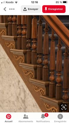 an ornate wooden stair case with marble flooring