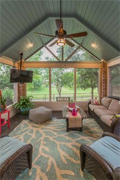 a living room with couches, chairs and a flat screen tv