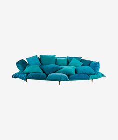 a blue couch with lots of pillows on it