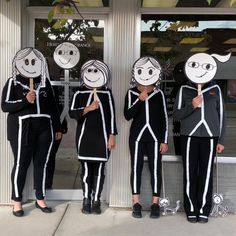 three children in costumes standing outside with their faces painted like skeletons and holding up signs