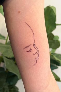 a woman's arm with a small line drawing of a face on the side