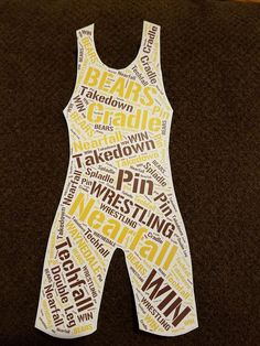 a piece of paper cut out to look like a wrestling wrestler's uniform with words written all over it