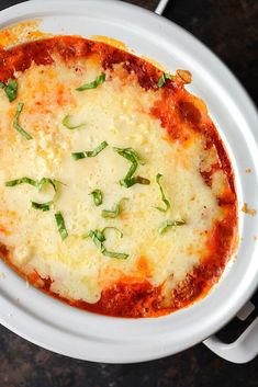 a white plate topped with a cheesy pizza