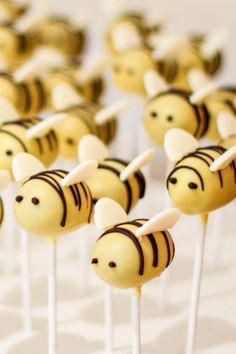 cake pops decorated like bees on top of each other